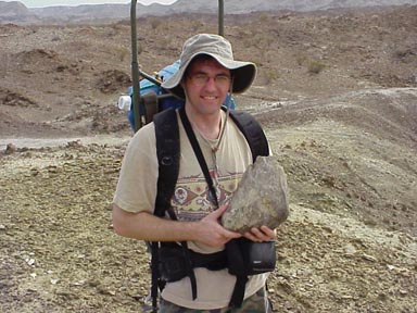 Me holding a juvenile Alamosaurus femur fragment